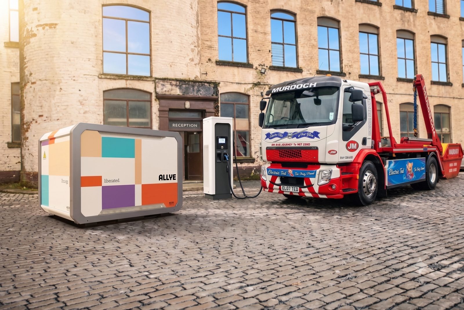 J&M Murdoch electric skip truck beside an Allye MAX300 and DC fast charger